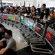 Anti-government protesters stand at a barricade made of trolleys during a demonstration at Hong Kong airport, Aug. 13, 2019.